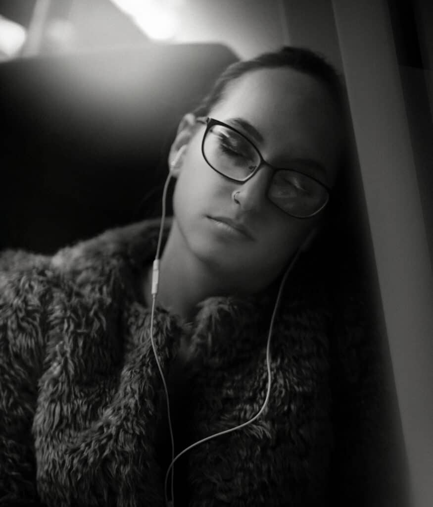 Lady asleep with comfortable earbuds in