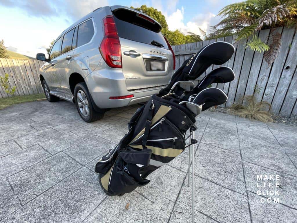 Haval H9 with a set of golf clubs sitting behind it ready to load